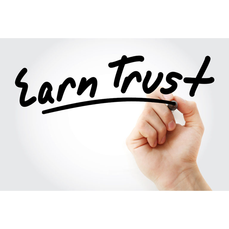 Hand writing Earn Trust with marker, concept background